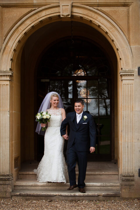 bride and groom exiting venue after getting married at Coombe Lodge